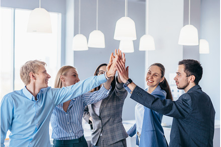 Business team giving high fives, a Person Photo by undrey