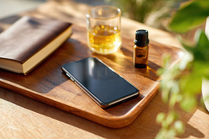 Creating a calming environment with essential oils and journaling in a sunlit s, a Technology Photo by AlyaAnd