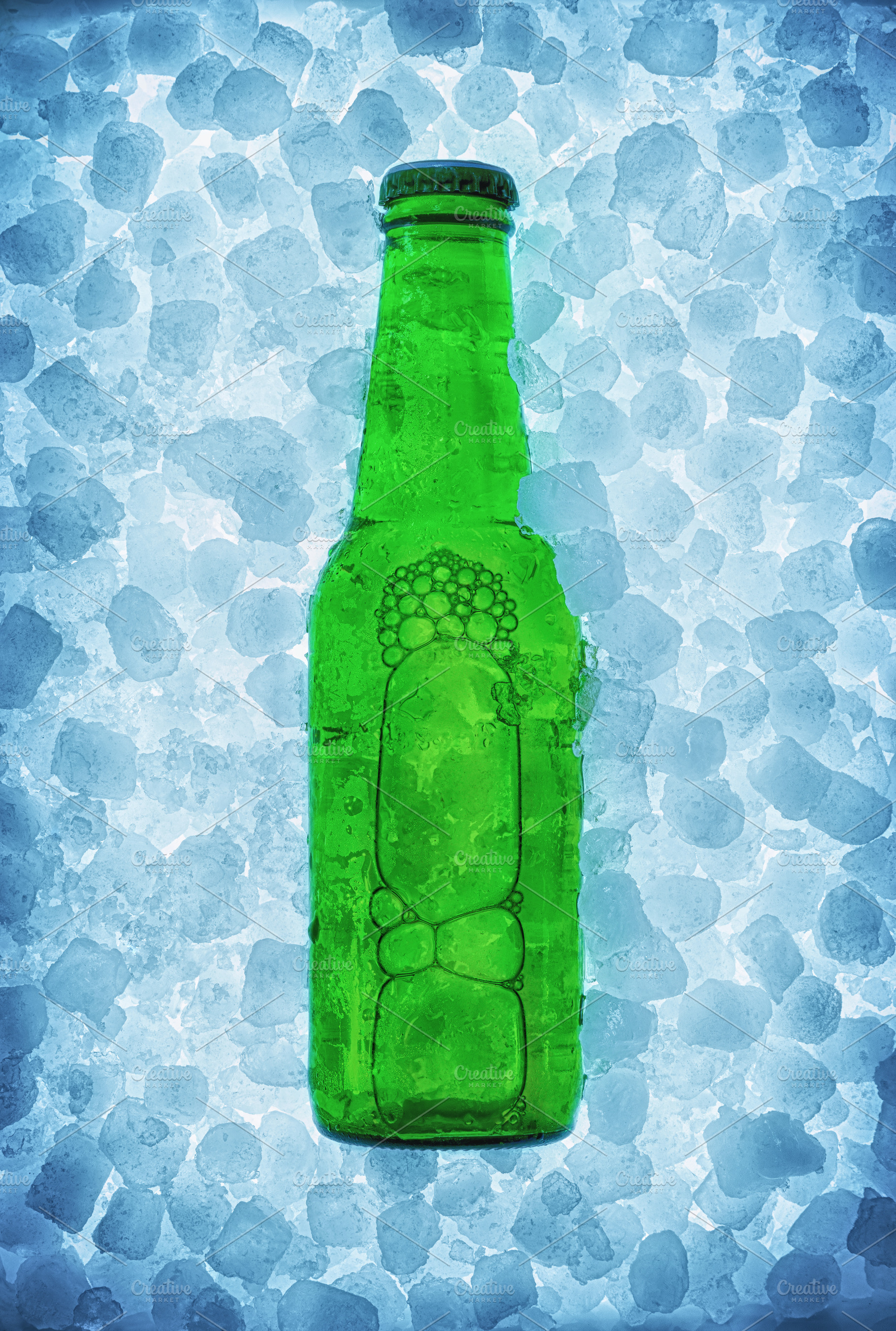 Green beer bottle buried on pile of ice cubes backlit, a Food & Drink Photo by Davizro's Market