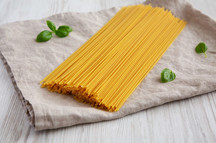 Raw Organic Spaghetti Pasta in a Bunch, side view., a Food & Drink Photo by LiudmylaChuhunova