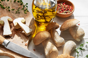 Preparing porcini mushrooms with olive oil and herbs, a Food & Drink Photo by Olena Rudo