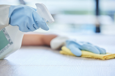 One unknown young mixed race woman cleaning the surfaces of her home. Unrecognizable Hispanic domestic worker wiping a table, a Photo by Peopleimages.com