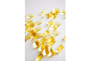 Fish oil omega capsules scattered on, a Health & Medical Photo by volodymyrshtun13795
