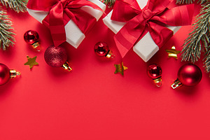 Christmas gifts and ornaments on red background border, a Holiday Photo by Olena Rudo