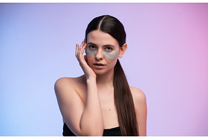 Young woman applying hydrogel eye, a Health & Medical Photo by volodymyrshtun13795