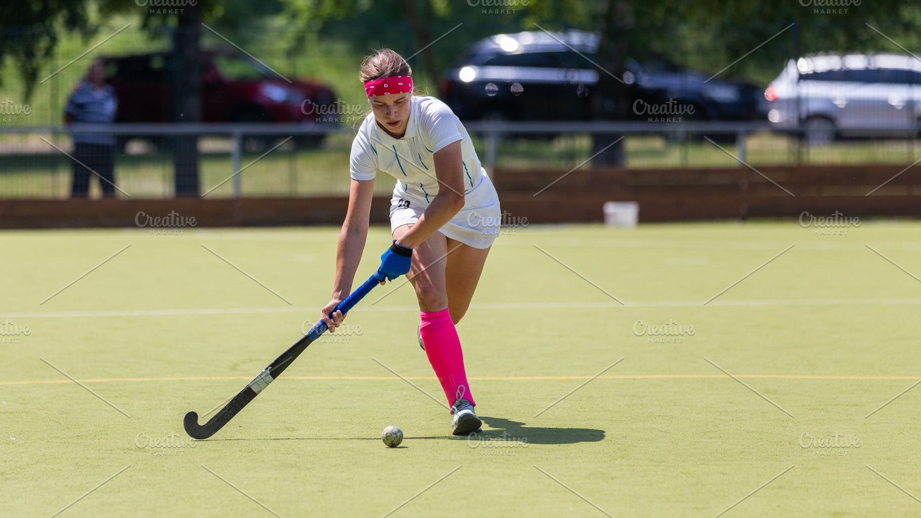 Young female player running with ball in attack on the pitch in field hockey ga, a Sports & Recreation Photo by serkum