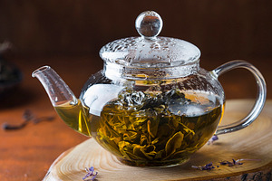 Green tea in a glass teapot featuring antioxidant, aromatic, and background