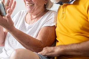 Senior couple enjoying a video call on a smartphone, a Person Photo by etorres69