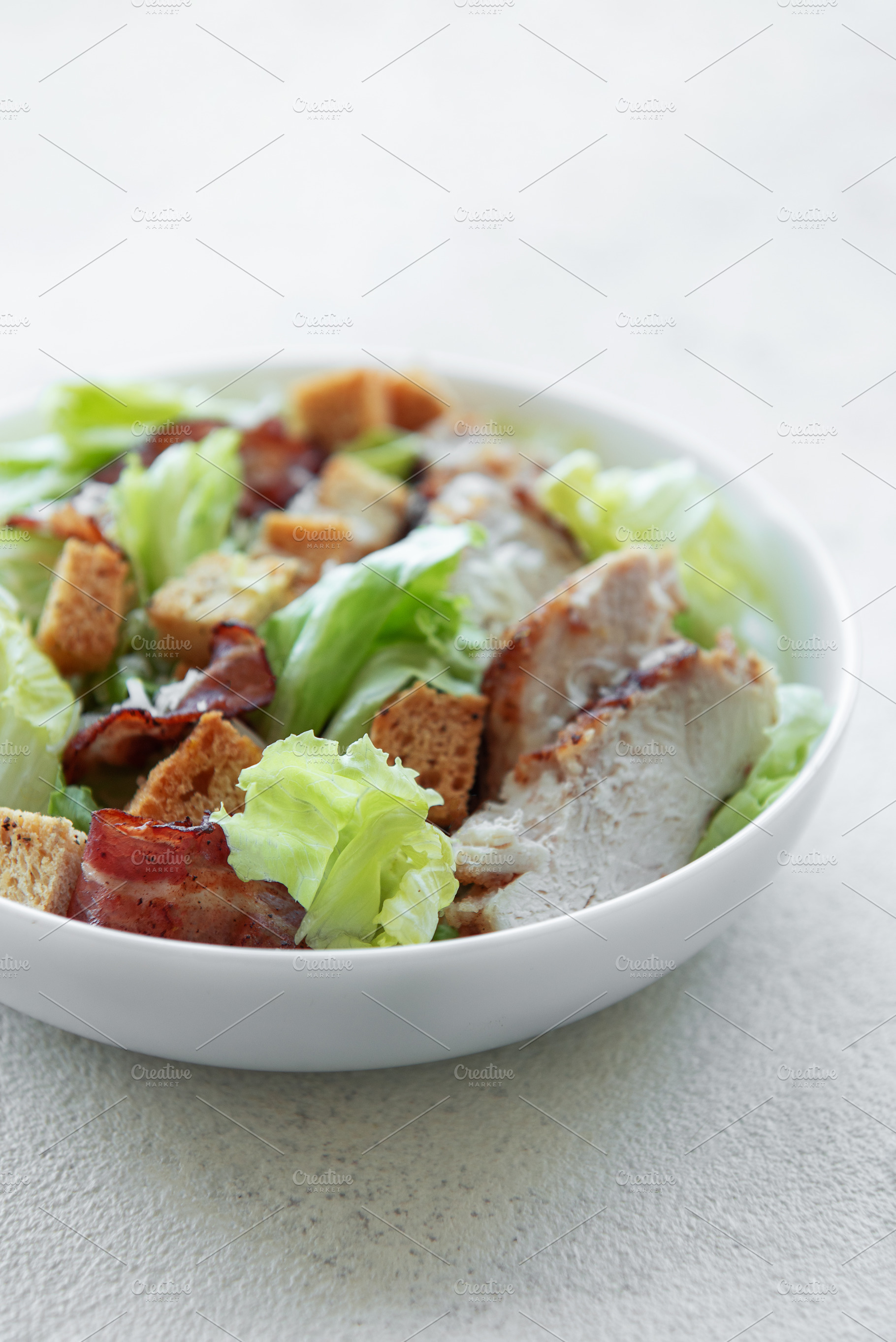A bowl  of  Caesar salad, a Photo by Olena Rudo