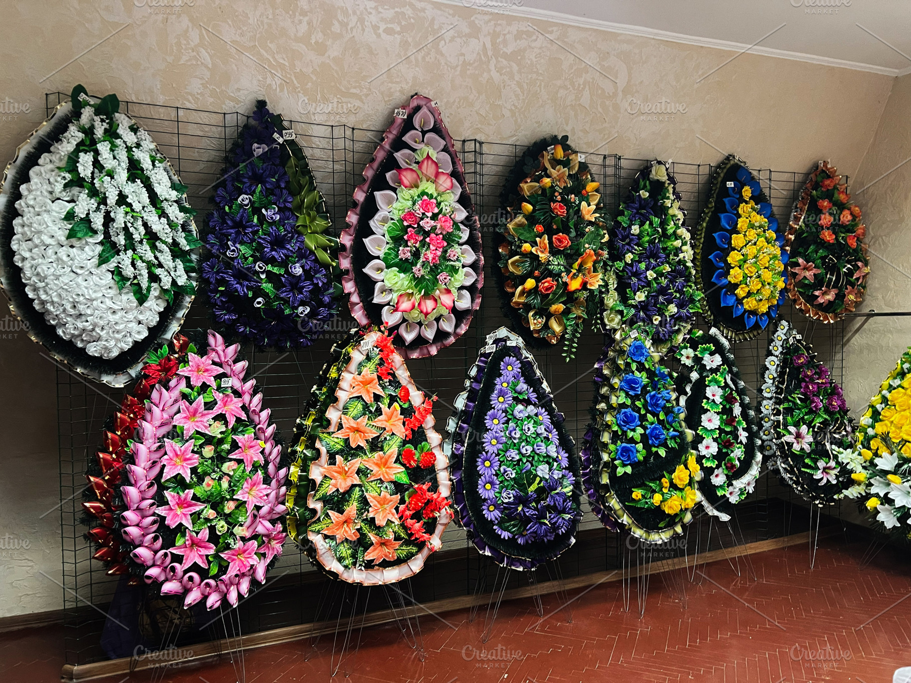 Colorful display of floral wreaths for decorative and ceremonial purposes indoo, a Photo by AS photostudio