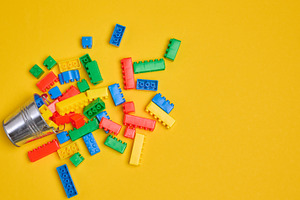 Vibrant colorful building bricks spilling from a silver metal bu, a School & Education Photo by ndanko