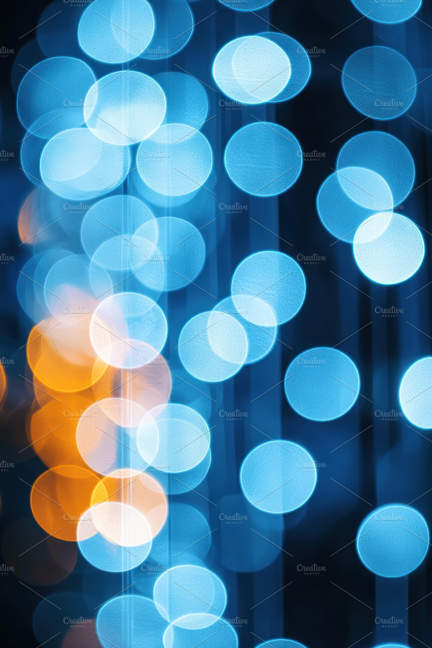 Vertical strands of glowing blue and orange bokeh lights with so, an Abstract Photo by José Manuel Gelpi