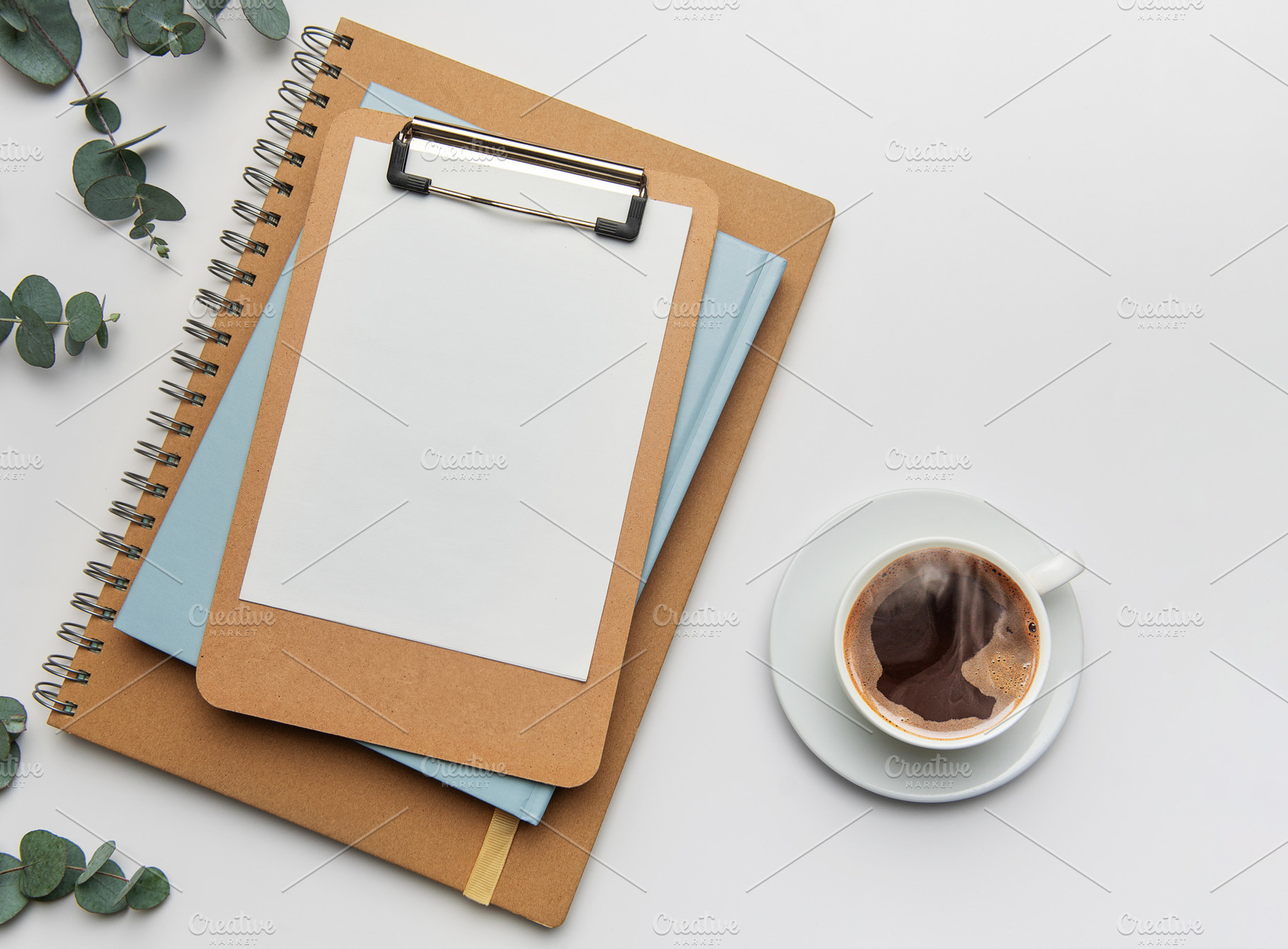 Clipboard with blank paper, notebooks and coffee cup on white ta, a Business Photo by Olena Rudo