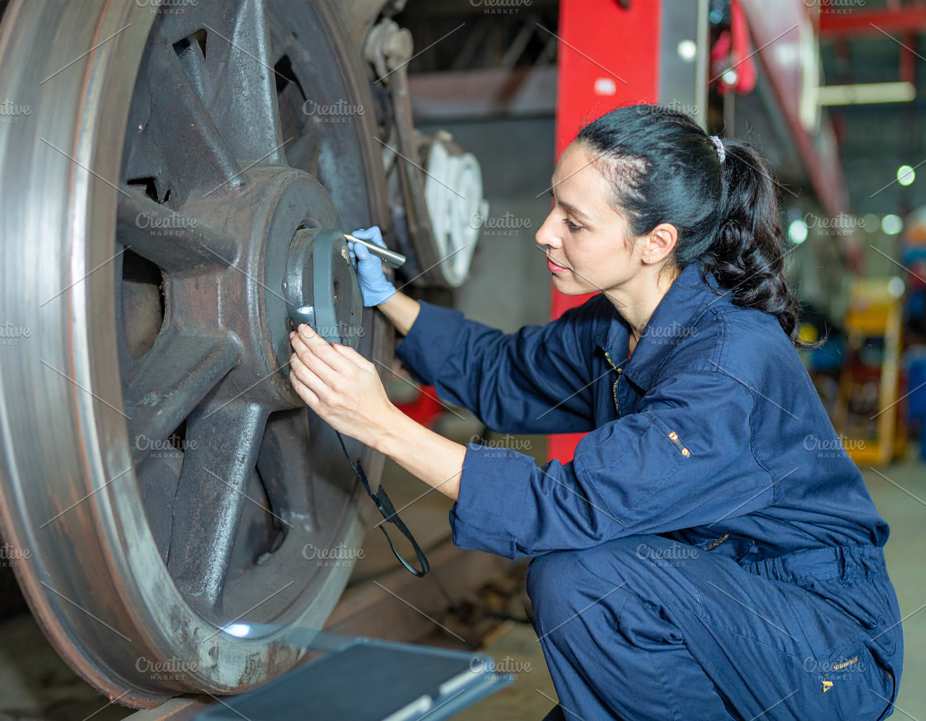 Train mechanic checking a train wheel, an Industrial Photo by DanFLCreativo