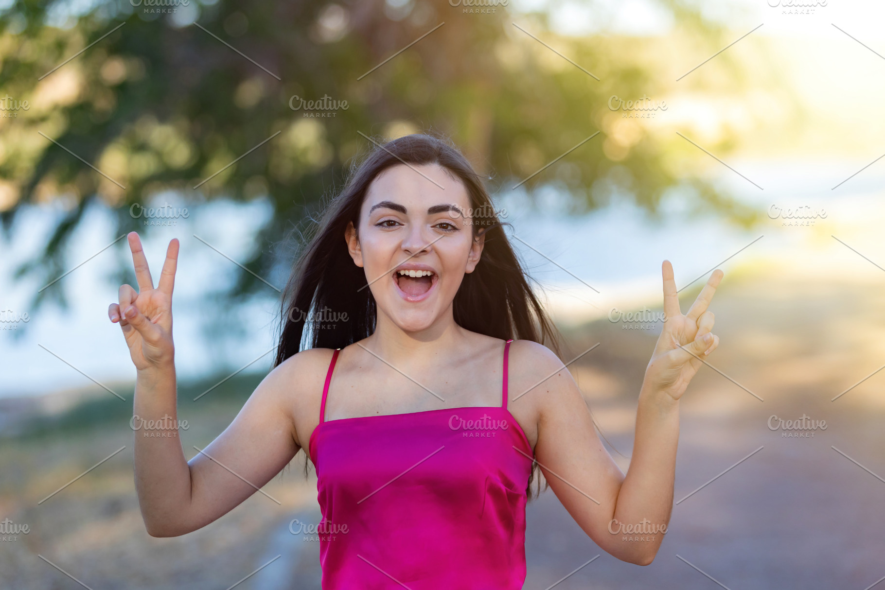 Winner girl spending a day in a park doing the victory sign, a Person Photo by José Manuel Gelpi