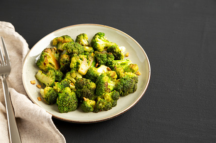 Homemade Pan-Fried Broccoli on a Plate on a black background, si, a Food & Drink Photo by LiudmylaChuhunova