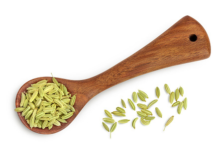 Dried fennel seeds in wooden spoon, a Food & Drink Photo by NataPhoto