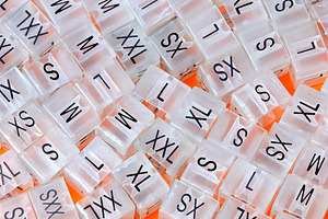 Various plastic clothing size tags featuring size, xxs, and xs