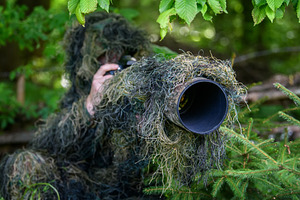 Wildlife photographer in the summer ghillie camouflage suit, a Person Photo by Byrdyak