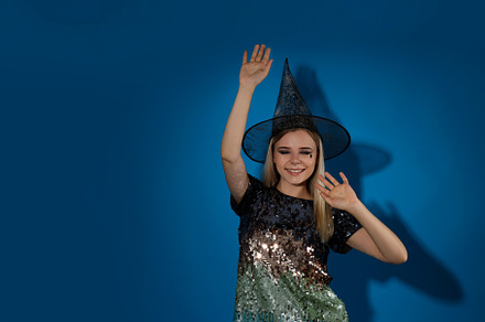 Concept of Halloween, young woman on blue background, a Person Photo by AtlasStudio PRO