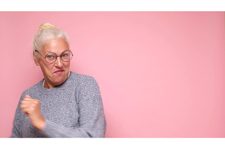 An elderly European woman in glasses