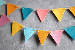 Colorful paper triangle bunting flags create festive atmosphere in celebration, a Background Photo by AlyaAnd