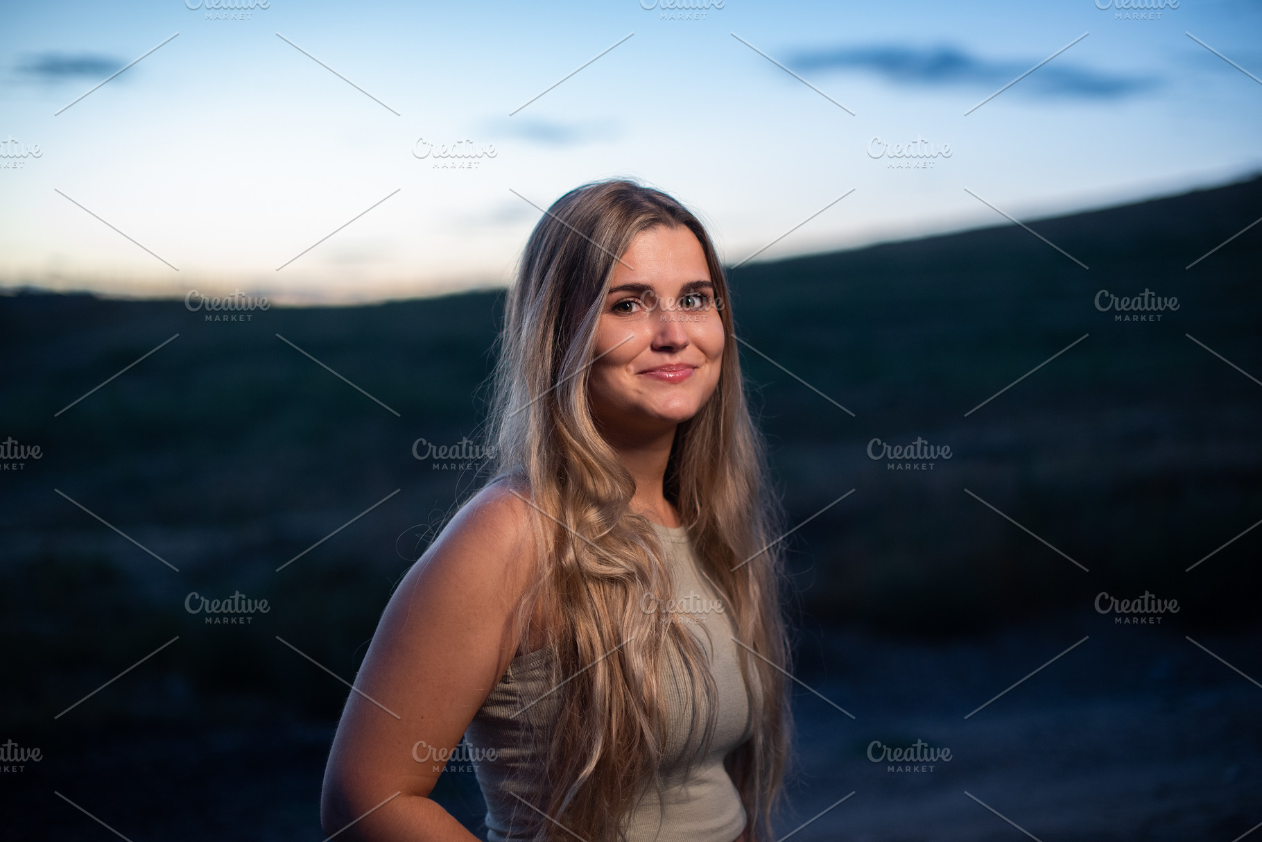 Portrait of a blonde caucasian woman smiling while gets dark, a Person Photo by Iván Moreno STOCK PHOTO