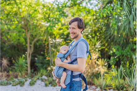 Young father walks in nature with