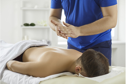 Young man relaxing during massage, a Health & Medical Photo by StudioRomantic