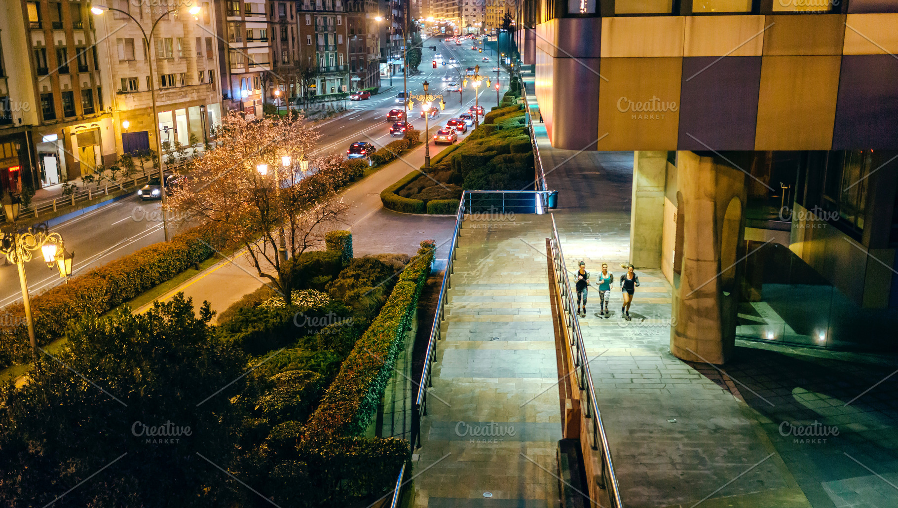 Women friends runners training together on the city at night, a Sports & Recreation Photo by davidpereiras
