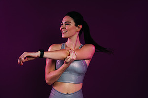 Smiling slim female flexing her hand, a Sports & Recreation Photo by Artem Varnitsin