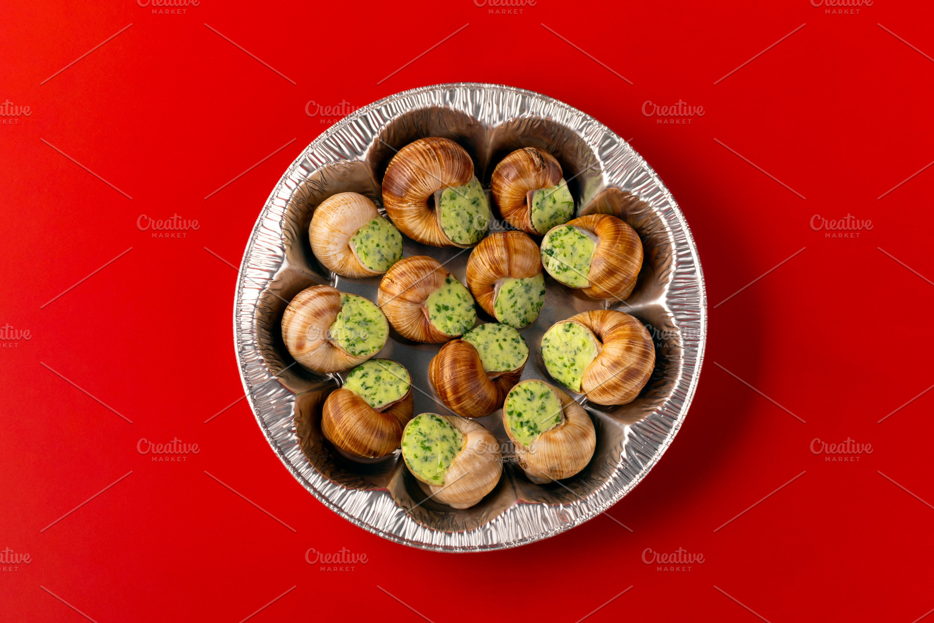 Baked escargot with parsley garlic butter presented in a foil di, a Food & Drink Photo by Ales Munt