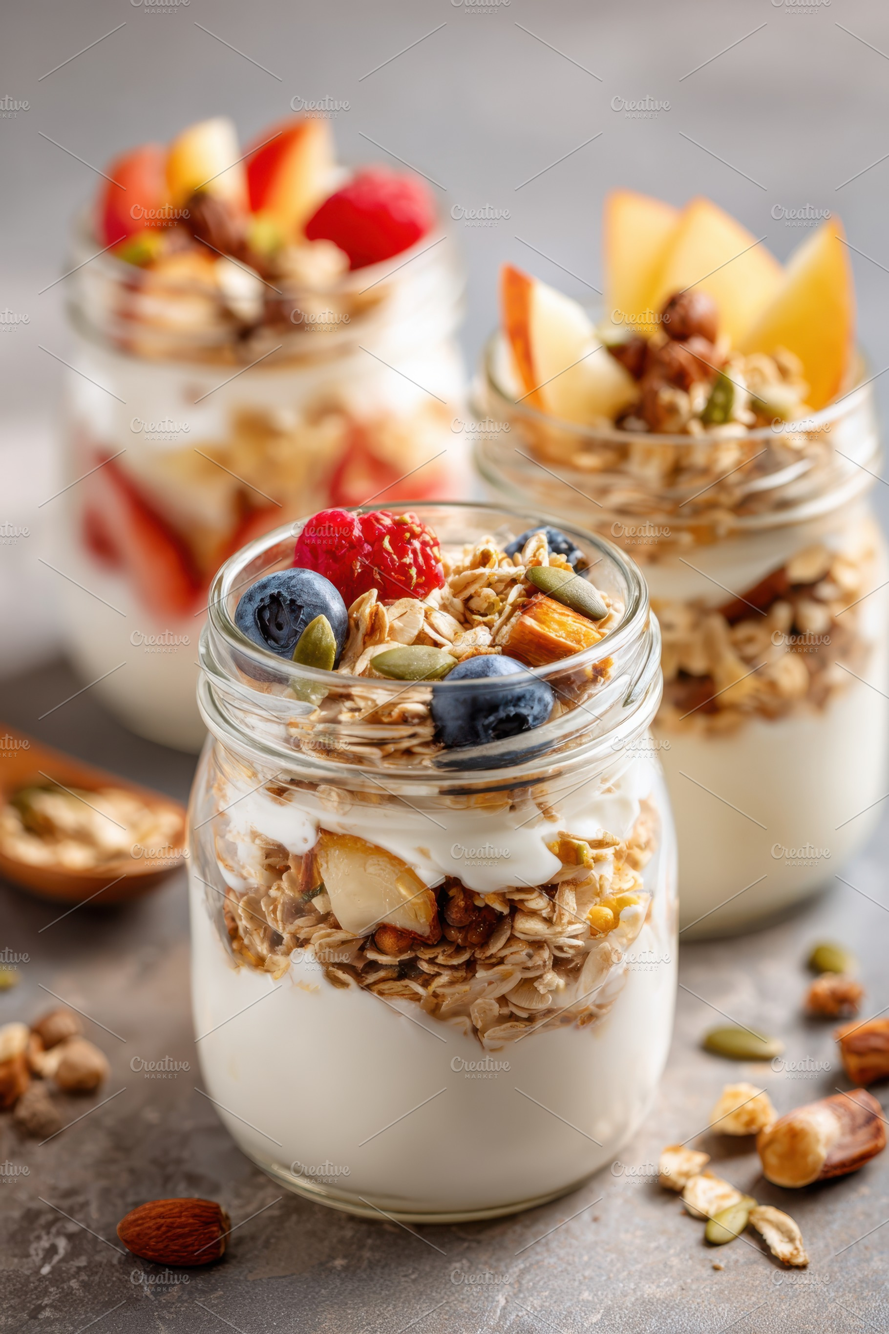 Layered yogurt parfait with fruits and granola, a Food & Drink Photo by AlyaAnd