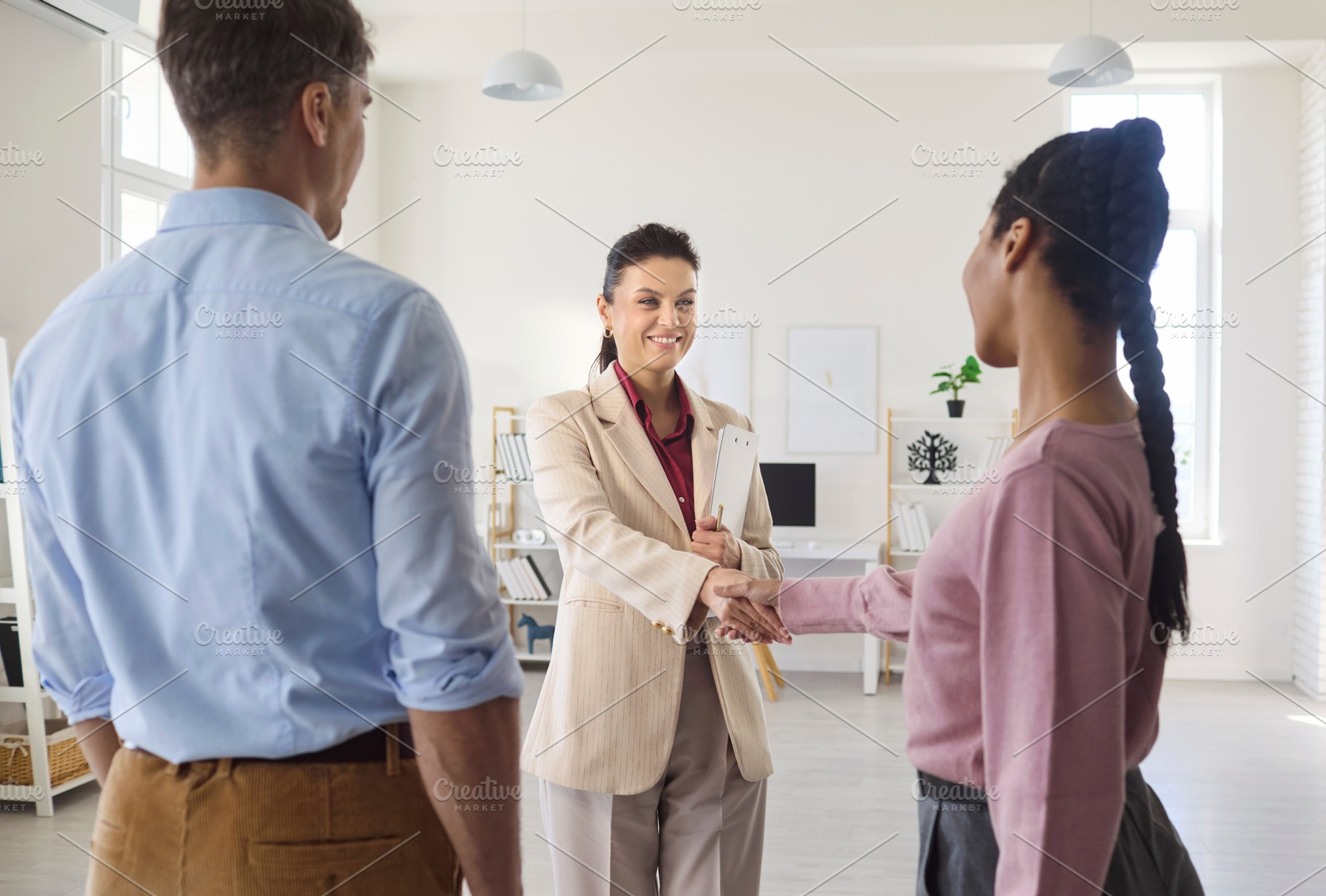 Realtor Greeting Couple at Viewing, a Person Photo by StudioRomantic