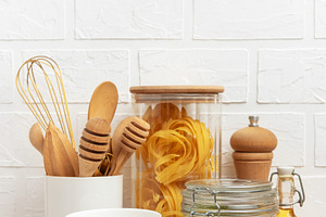 Kitchen utensils, pasta, mung beans and oil creating a cozy culi, a Food & Drink Photo by Olena Rudo