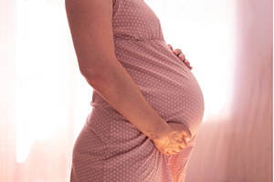 Pregnant woman touching belly