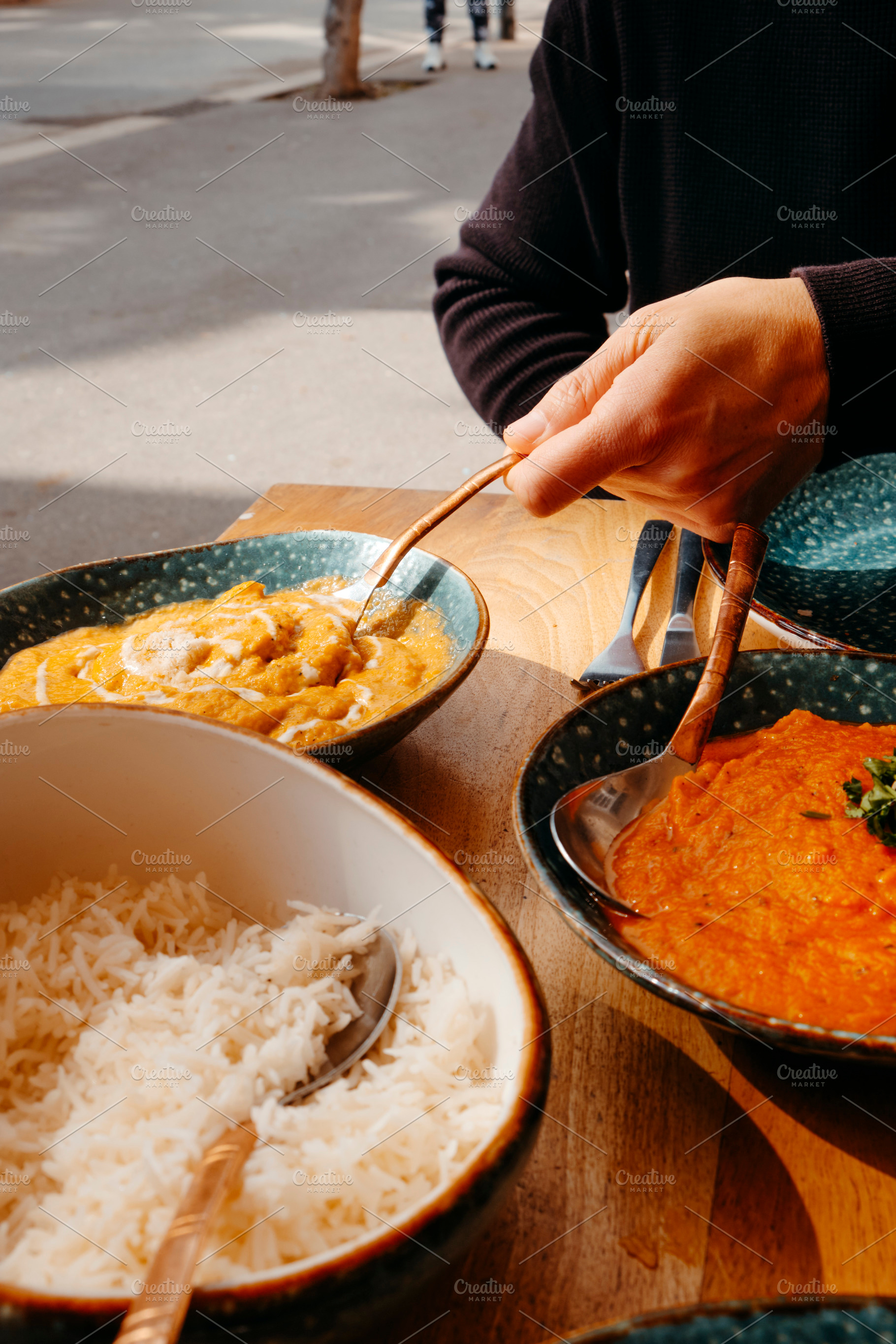 man about to serve some chicken korma, a Photo by Nito