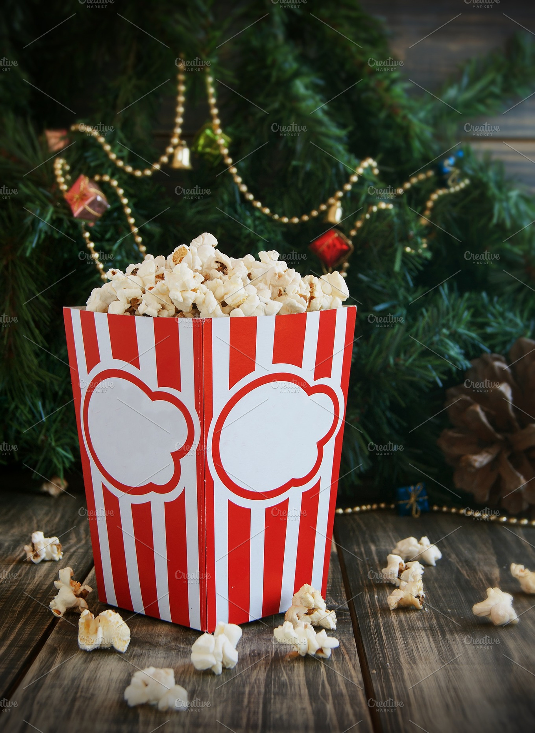 Popcorn in the cup on background of christmas trees and decorations, a Food & Drink Photo by Wild Drago Shop