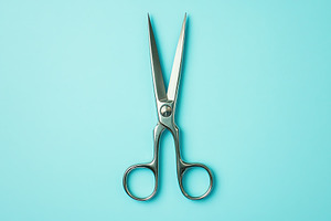 Sterile surgical scissors on blue background, a Health & Medical Photo by AlyaAnd