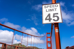 Golden Gate Bridge road view with red suspension cables, San Fra, an Architecture Photo by GoodGoods
