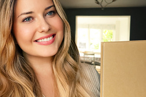 Young woman smiling, holding an unboxing parcel or happy gift bo, a Person Photo by Studio ANNA