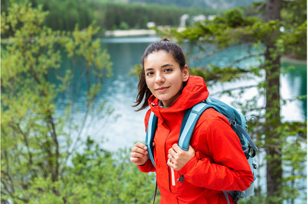 Beautiful woman in red raincoat, a Sports & Recreation Photo by AD Stock Images