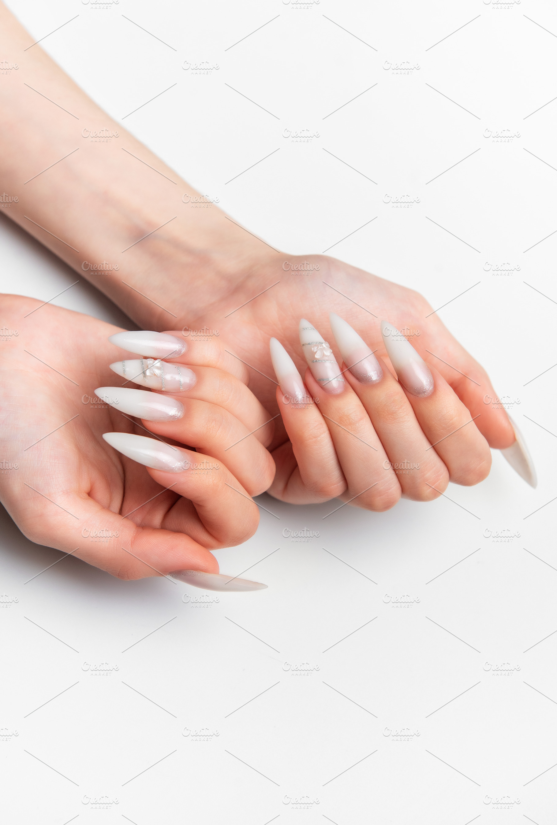 Woman's hands showing long white stiletto nail art manicure, a Beauty & Fashion Photo by Olena Rudo