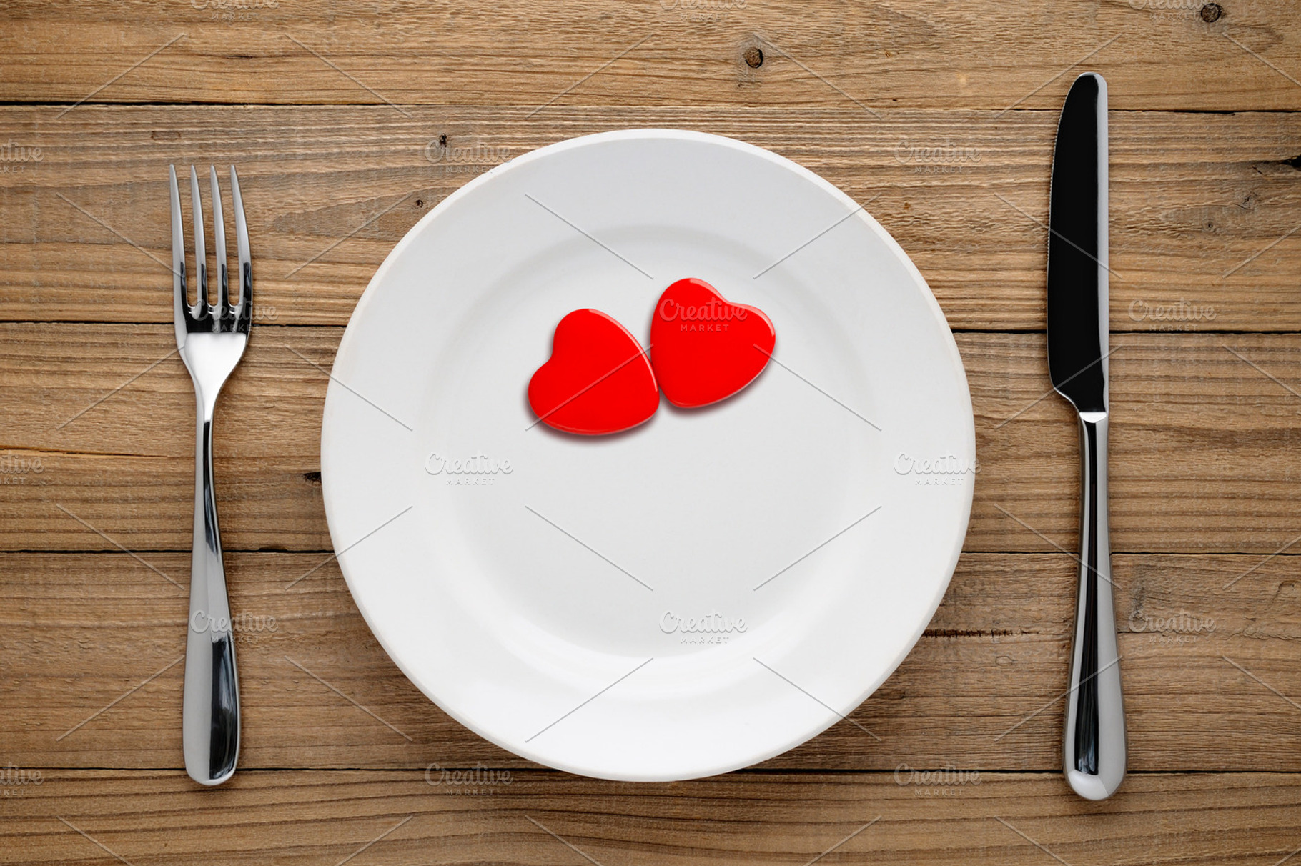 Two red hearts on plate