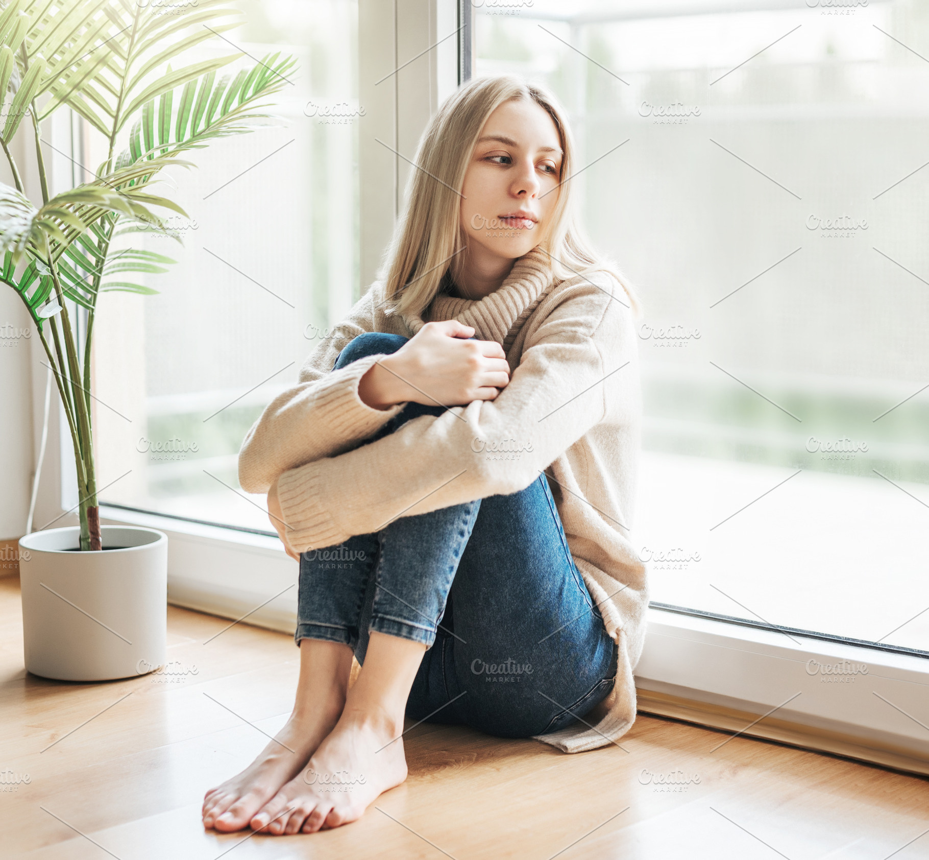 Sad girl near window thinking about something, a Person Photo by Olena Rudo