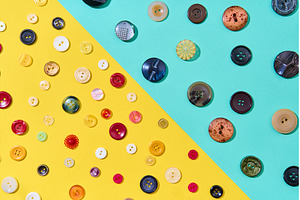 Assorted sewing buttons on yellow