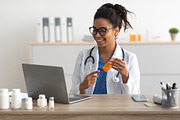 Portrait of black female medical practitioner using laptop, a Photo by Prostock-Studio (Thumbnail 2 of 2)