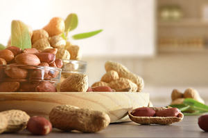 Peanuts in glass bowls on wooden bench in kitchen, a Food & Drink Photo by Davizro's Market