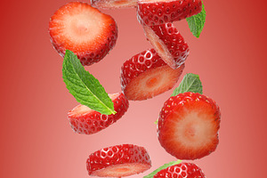 Lots of strawberry pieces and mint leaves flying on red gradient, a Food & Drink Photo by ndanko