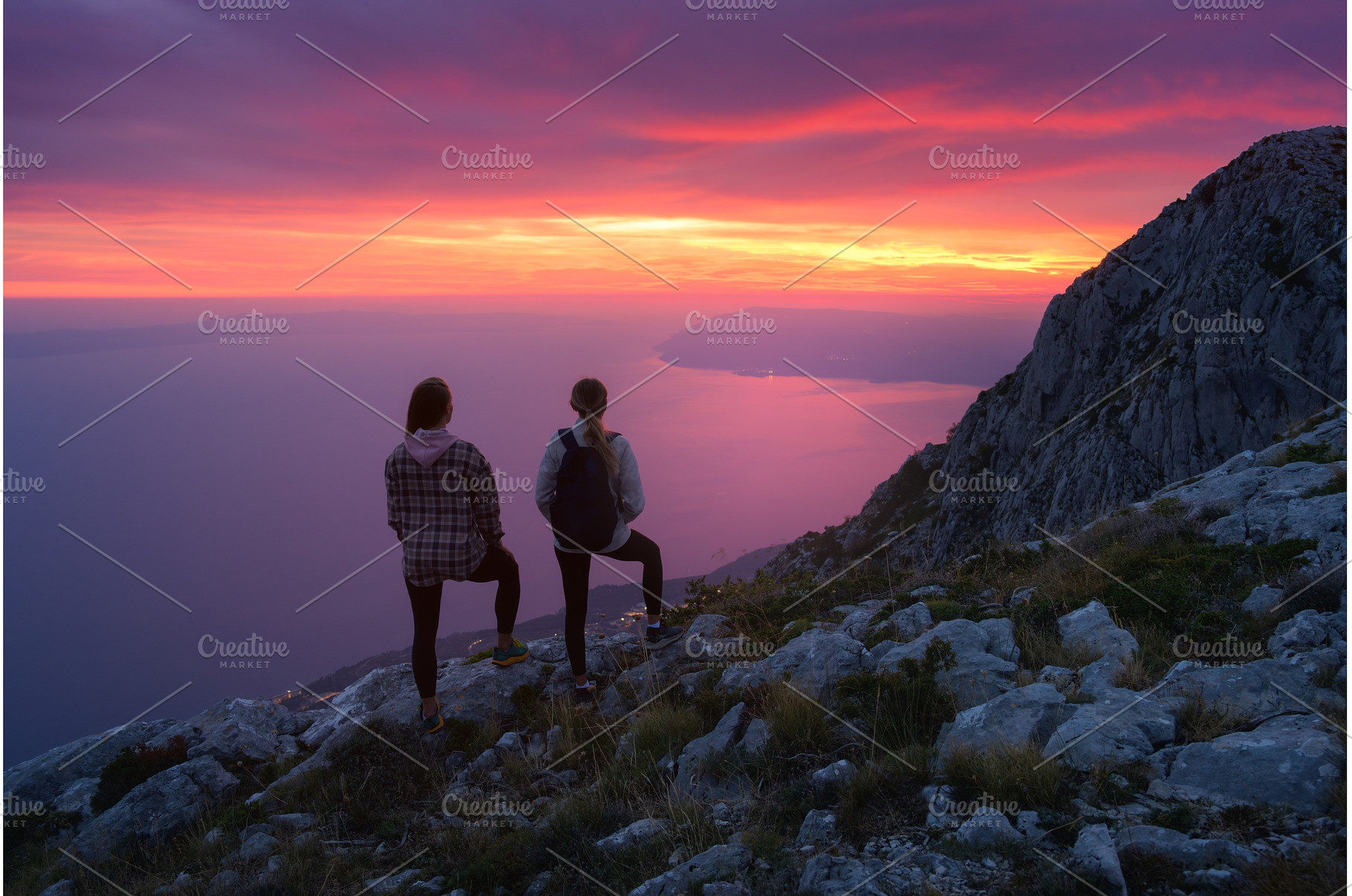 Two women hikers with backpacks, a Person Photo by den-belitsky